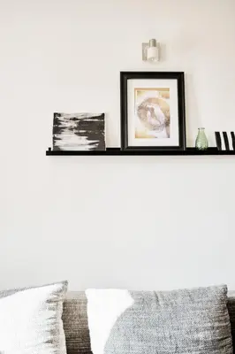 a shelf above a couch with two pictures on it at LIL Apartment with Tyn Cathedral View, Parking & AC in Prague