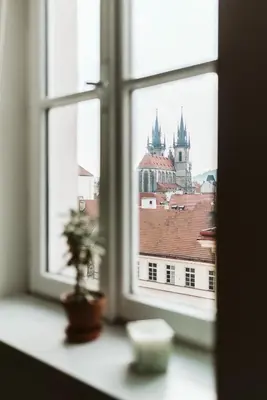 a view of a city from a window at LIL Apartment with Tyn Cathedral View, Parking & AC in Prague