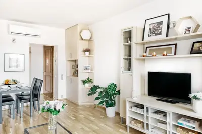 a living room with a television and a dining room at LIL Apartment with Tyn Cathedral View, Parking & AC in Prague