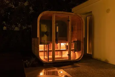 a round room with a glass door on the side of a building at Relax u potoka, vířivka, swimSpa, sauna