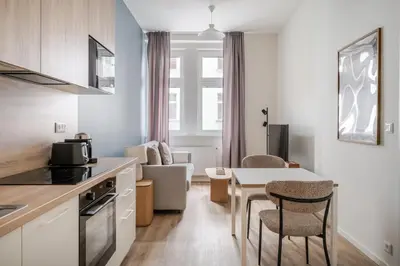 a kitchen and living room with a table and chairs at Blueground Holešovice view nr Vltava PRG-60 in Prague