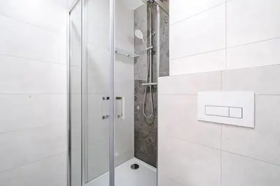 a shower with a glass door in a bathroom at Blueground Holešovice view nr Vltava PRG-60 in Prague