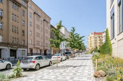 a city street with parked cars and buildings at Blueground Holešovice view nr Vltava PRG-60 in Prague
