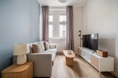a living room with a couch and a tv at Blueground Holešovice view nr Vltava PRG-60 in Prague