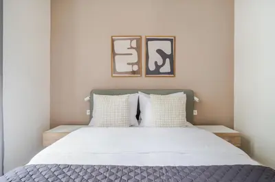 a bedroom with a bed with white sheets and pillows at Blueground Holešovice view nr Vltava PRG-60 in Prague