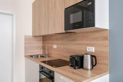a kitchen with a sink and a microwave at Blueground Holešovice view nr Vltava PRG-60 in Prague