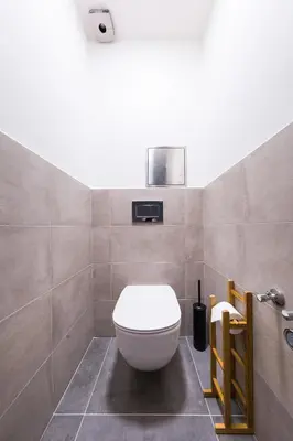 a bathroom with a white toilet in a room at Bohéme Apartments Folimanka in Prague