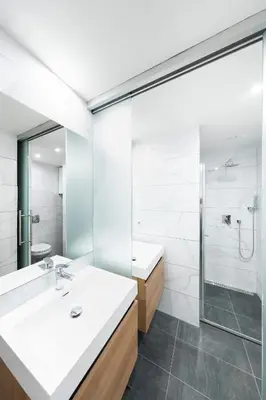 a bathroom with a sink and a shower at Bohéme Apartments Folimanka in Prague