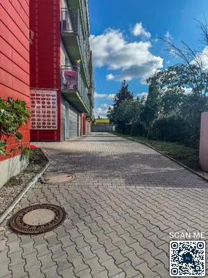 a cobblestone street next to a red building at YCZ Praha in Prague