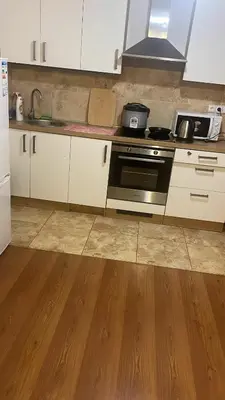 a kitchen with white cabinets and a stove top oven at YCZ Praha in Prague