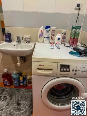 a bathroom with a washing machine and a sink at YCZ Praha in Prague