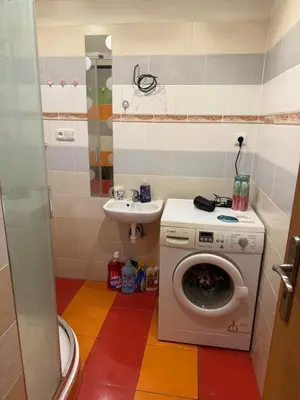 a bathroom with a washing machine and a sink at YCZ Praha in Prague