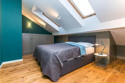 a bedroom with a bed and a skylight at Funky lux 2 bedroom loft in the Old Town in Prague