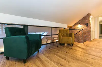 a living room with two chairs and a table at Funky lux 2 bedroom loft in the Old Town in Prague