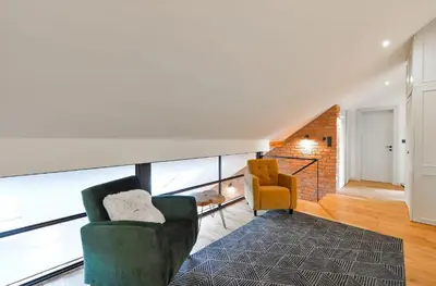 a living room with two chairs and a couch at Funky lux 2 bedroom loft in the Old Town in Prague
