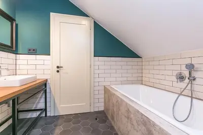 a bathroom with a tub and a sink at Funky lux 2 bedroom loft in the Old Town in Prague