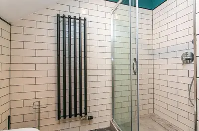 a shower with a glass door in a bathroom at Funky lux 2 bedroom loft in the Old Town in Prague