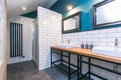 a bathroom with two sinks and two mirrors at Funky lux 2 bedroom loft in the Old Town in Prague