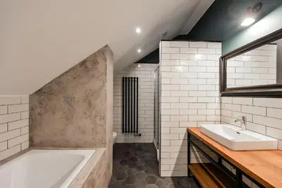 a bathroom with a bath tub and a sink at Funky lux 2 bedroom loft in the Old Town in Prague