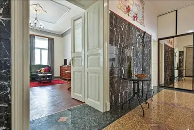 a room with a hallway with a door and a table at Golden Prague Residence, Jáchymova Street in Prague