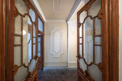 a hallway with wood cabinets and a mirror on the wall at Golden Prague Residence, Jáchymova Street in Prague