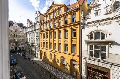 a yellow building on the side of a street at Golden Prague Residence, Jáchymova Street in Prague