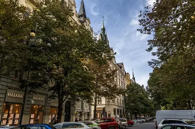 a city street with cars parked in front of buildings at Golden Prague Residence, Jáchymova Street in Prague