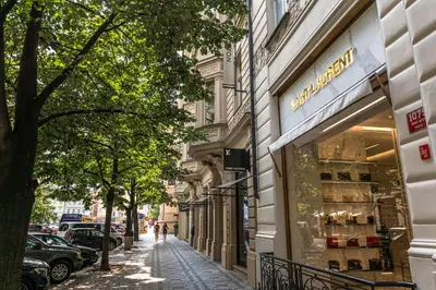 a street with a store on the side of a building at Spacious elegant apartment at the Old Town Square in Prague