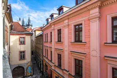 a row of buildings in a city with a cathedral at Spacious elegant apartment at the Old Town Square in Prague