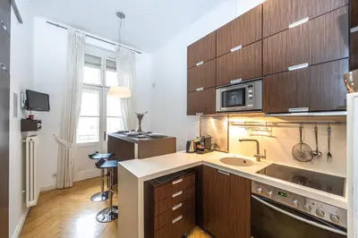 a kitchen with a sink and a microwave at Bohemian charm apartment by Paris Avenue 1 in Prague
