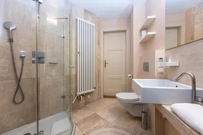 a bathroom with a shower and a sink and a toilet at Bohemian charm apartment by Paris Avenue 1 in Prague