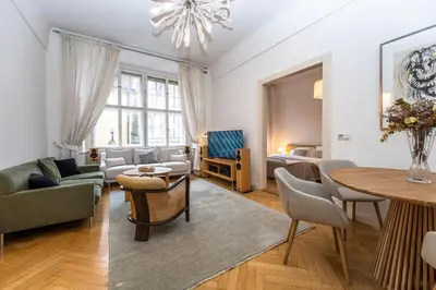 a living room with a couch and a table at Bohemian charm apartment by Paris Avenue 1 in Prague