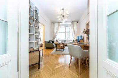 a living room with a desk and a dining room at Bohemian charm apartment by Paris Avenue 1 in Prague