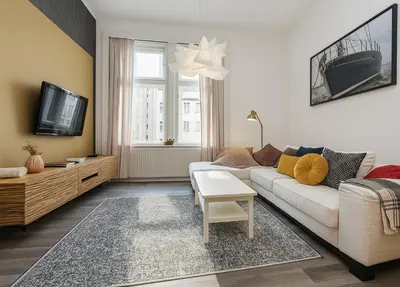 a living room with a white couch and a tv at Cozy apartment with 2 bedrooms in New Town in Prague