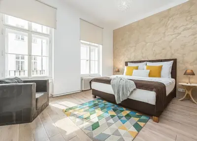 a bedroom with a king sized bed and a couch at Cozy apartment with 2 bedrooms in New Town in Prague