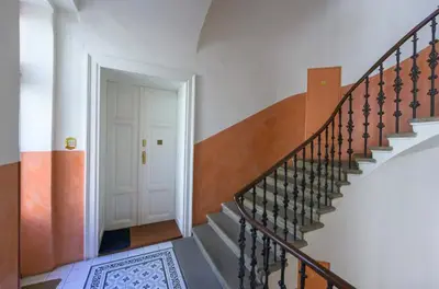 a stairway with a white door and a white and orange staircase at Cozy apartment with 2 bedrooms in New Town in Prague