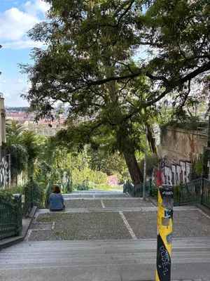 a street with train tracks on a city street at Charm Vinohrady in Prague