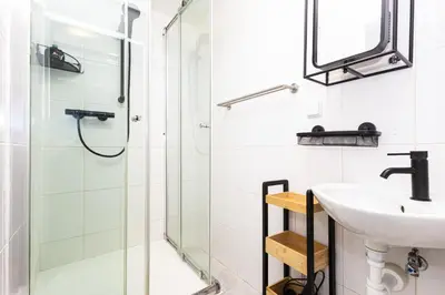 a bathroom with a sink and a shower at Charm Vinohrady in Prague