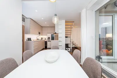 a kitchen and dining room with a white table and chairs at Amazing 3-Bedroom and Terrace overlooking TV Tower in Prague