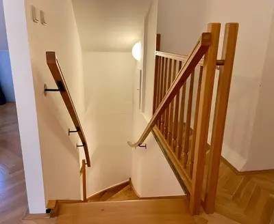 a staircase in a house with wooden railings at Central Cozy Comfort Loft in Prague