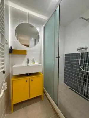 a bathroom with a sink and a shower at Negroni Apartment in Prague