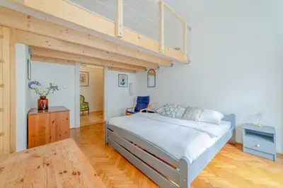 a bedroom with a bed and a loft at Charming Apartment in the Heart of Prague by Rentez in Prague