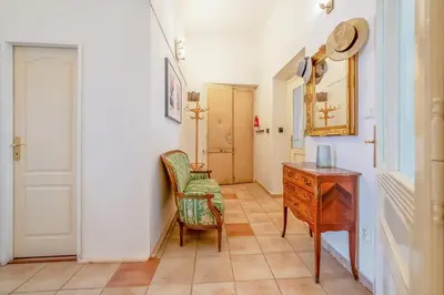 a hallway with a dresser and a chair and a desk at Charming Apartment in the Heart of Prague by Rentez in Prague