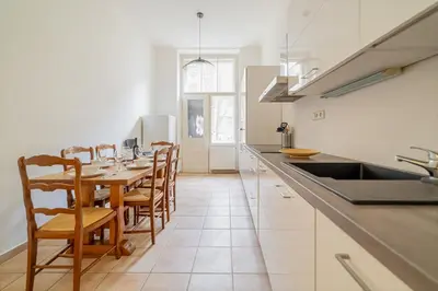 a kitchen with a table with chairs and a sink at Charming Apartment in the Heart of Prague by Rentez in Prague