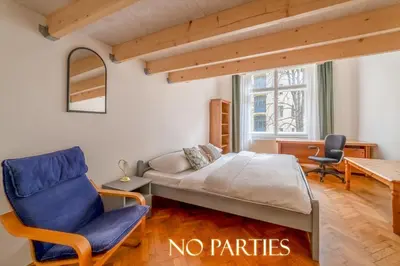 a bedroom with a bed and a chair and a table at Charming Apartment in the Heart of Prague by Rentez in Prague