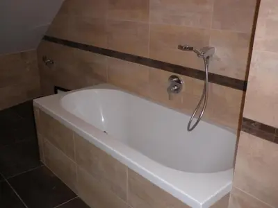a bath tub in a bathroom with a shower at Apartment Paradise Michalská in Prague