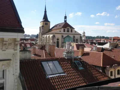 a view of roofs of a city with a church at Apartment Paradise Michalská in Prague