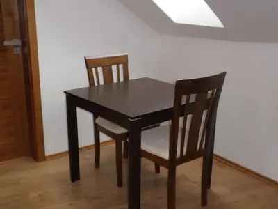 a black dining room table and two chairs at Apartment Paradise Michalská in Prague