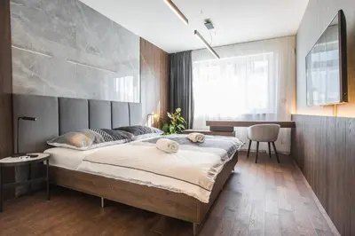 a bedroom with a large bed with a concrete wall at Parking Free Onsite, Air Conditioning, Wenceslas Square in Prague