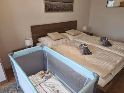 a bedroom with two beds and a crib at Prague Green Hideaway near Centre in Prague